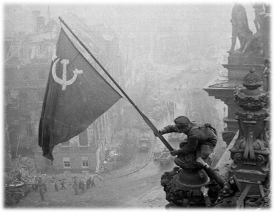 Red Army soldiers raising the Soviet flag on the Reichstag after conquering Berlin